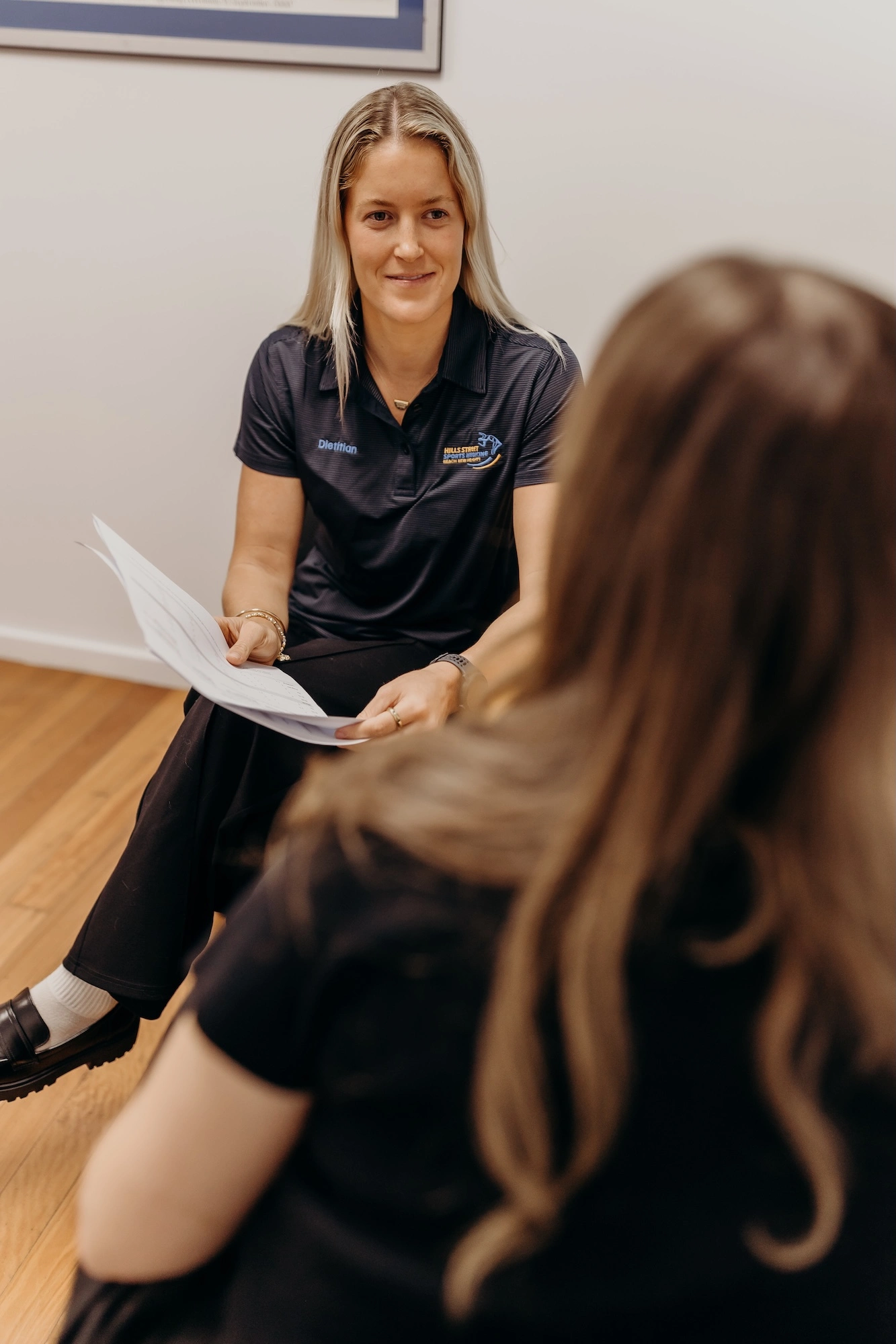 Female Accredited Practising Dietitian in Gosford consulting with a Central Coast client in clinic